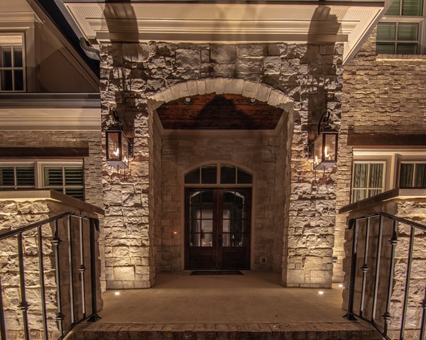 core drilled recessed up lights on front patio light stone columns at entrance to home