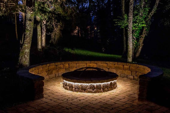 Outdoor LED strip lighting around backyard fire pit 