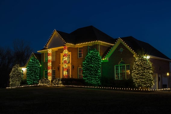 Holiday lighting with candy cane lights on columns
