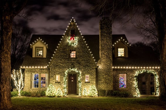 Holiday lights on home with stone facade