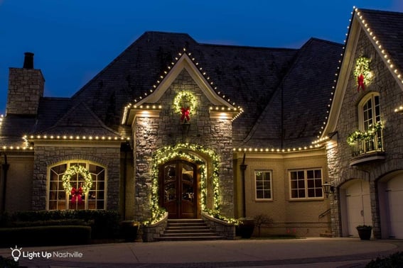 holiday lighting with garland around archway