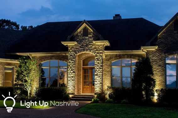 Front entry of home with good curb appeal lit by outdoor lighting from Light Up Nashville